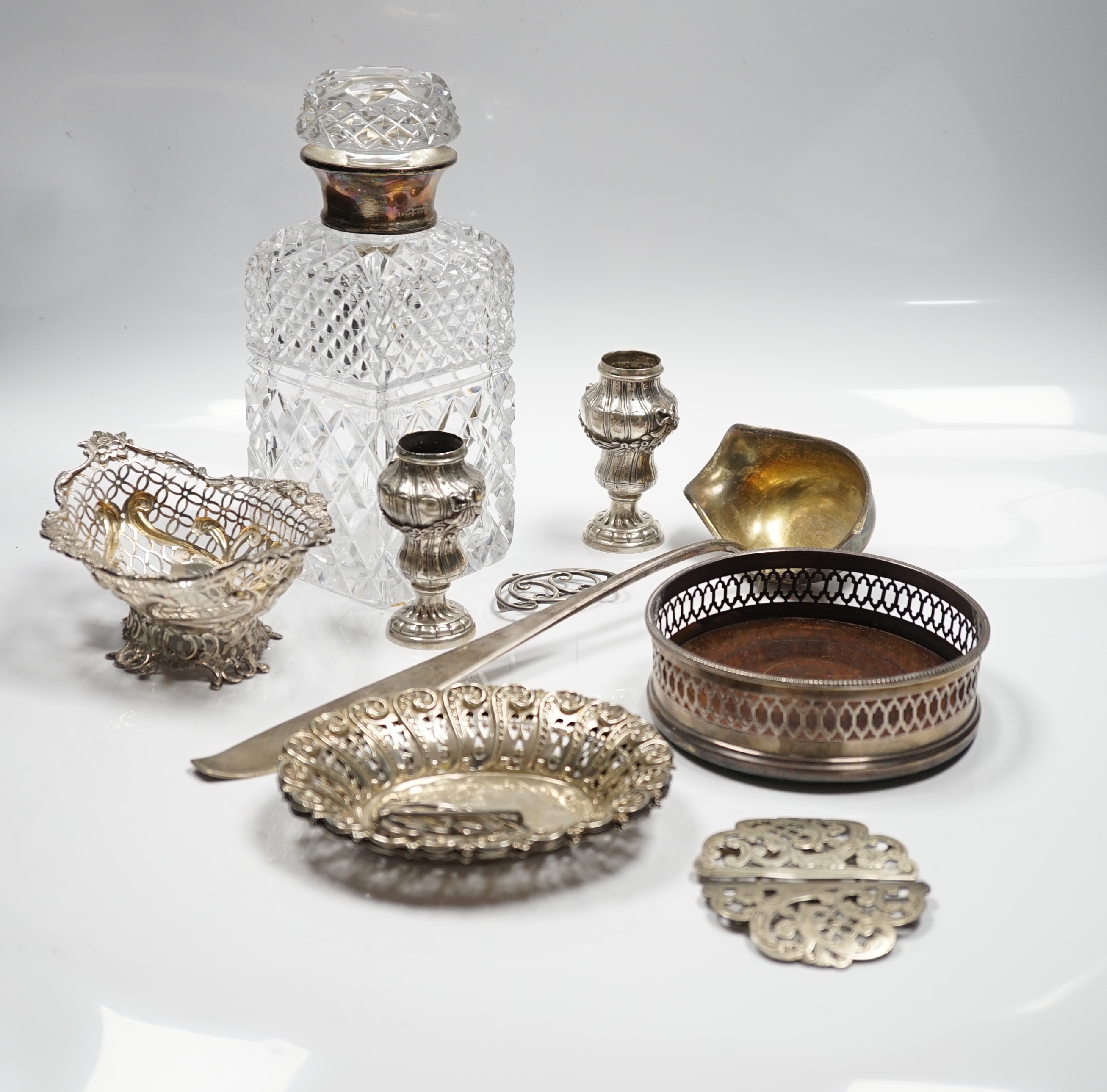 Assorted silver and white metal items including a pair of late Victorian pierced silver bonbon dishes, a pierced silver small bowl, a modern silver wine coaster, a silver belt buckle, white metal belt buckle, two contine